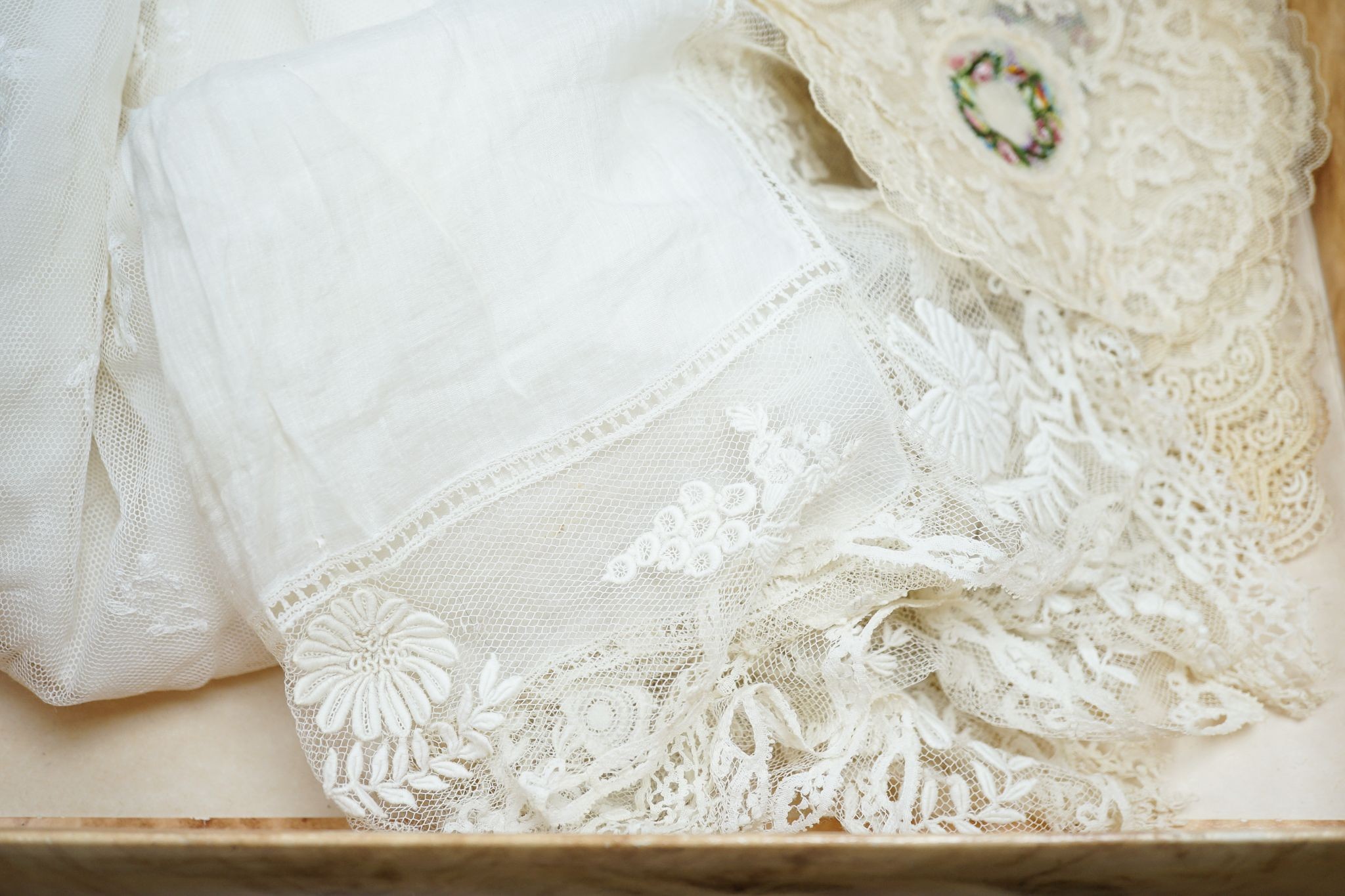 Two early 19th century, finely white worked lace hankies, various sets of lace mats and a lace baby dress, Hankies 40 cms x 40 cms.